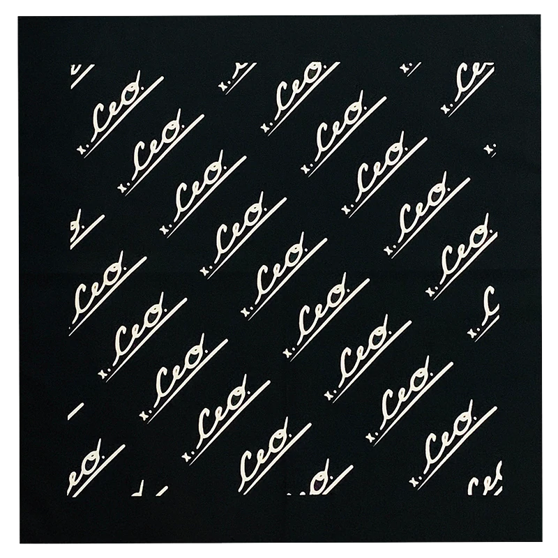 Flat lay of black CEO. Apparel bandana featuring a diagonal repeating white logo pattern.