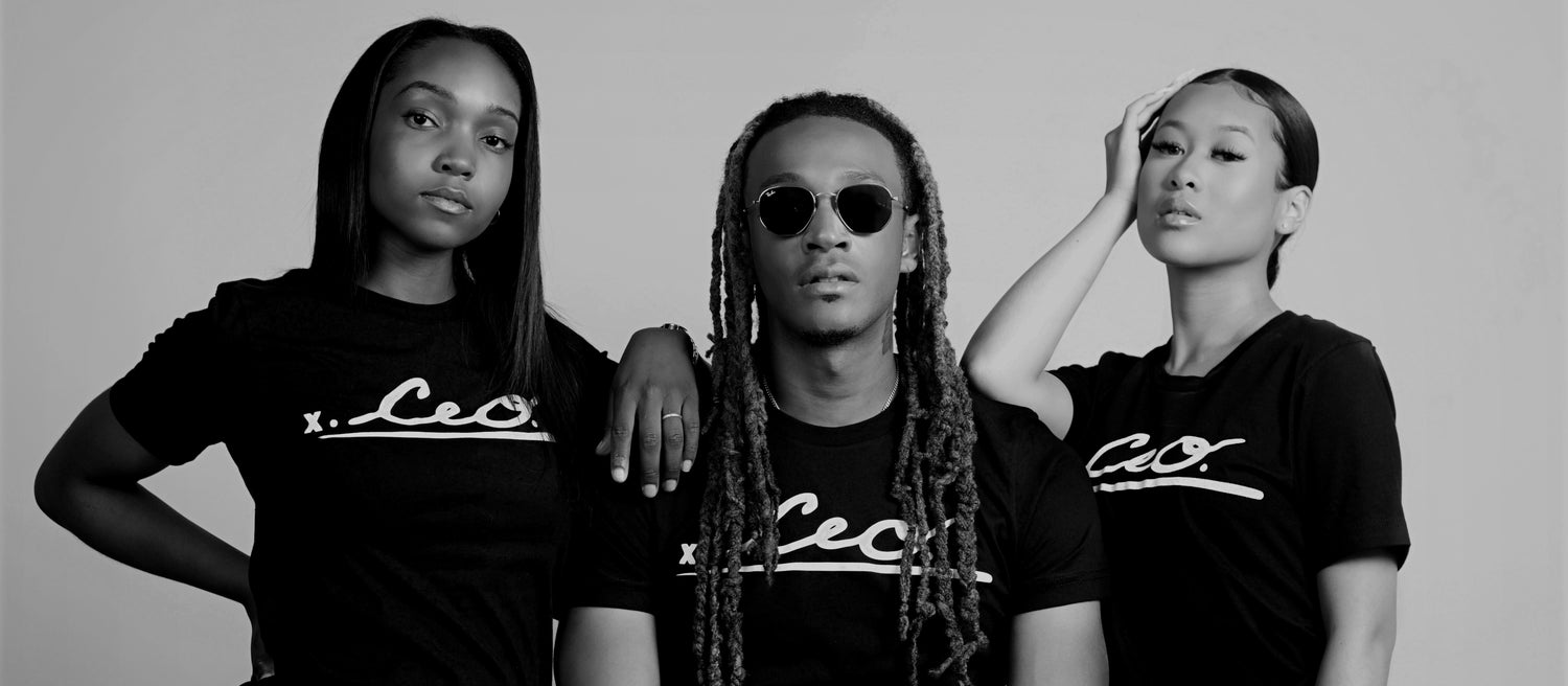 Three diverse models wearing black CEO. Apparel signature tees, standing confidently in a black-and-white portrait that reflects leadership, unity, and bold streetwear style.