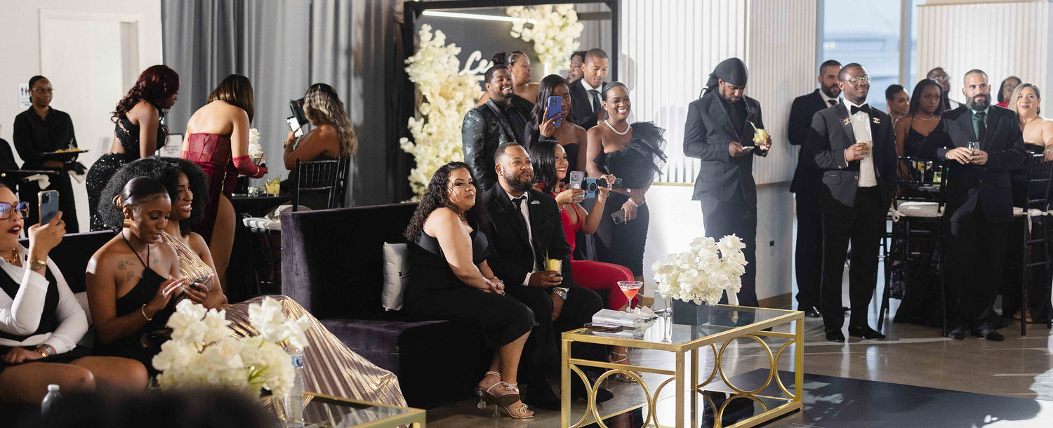 Guests dressed in formal black-tie attire enjoying The CEO. Ball, an upscale networking event celebrating ambition, community, and Black excellence.